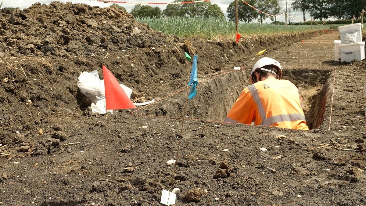 Archaeologists digging along construction site