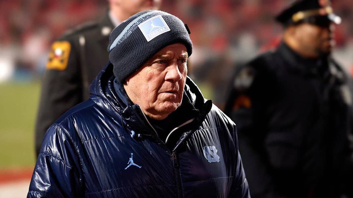 Bill Belichick walks off the field at Carter-Finley Stadium.