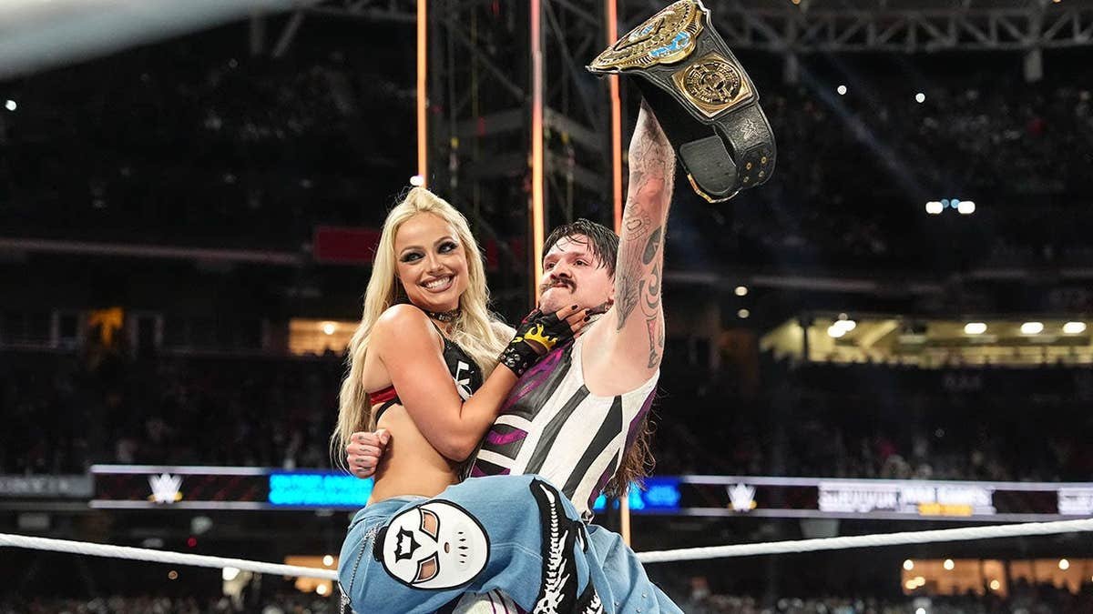 Liv Morgan and Dominik Mysterio celebrate at Petco Park.