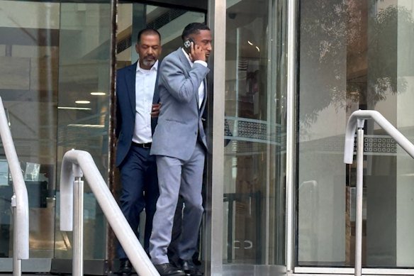 Yung Filly - real name Andres Felipe Valencia Barrientos, in the grey suit - leaves court after the first day of his trial on Monday.