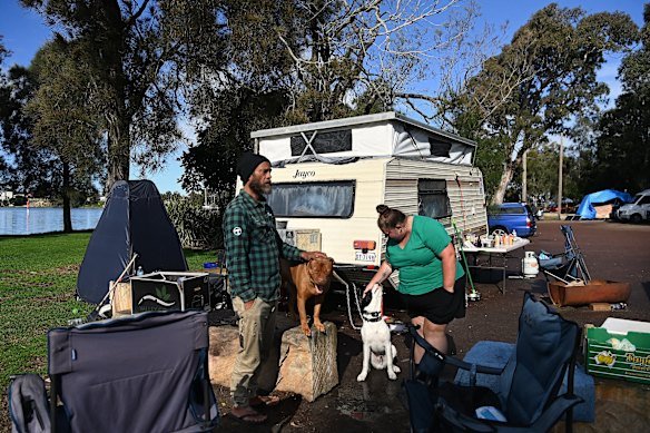 Friends Paul and Angie with their dogs at their encampment in Gorokan.