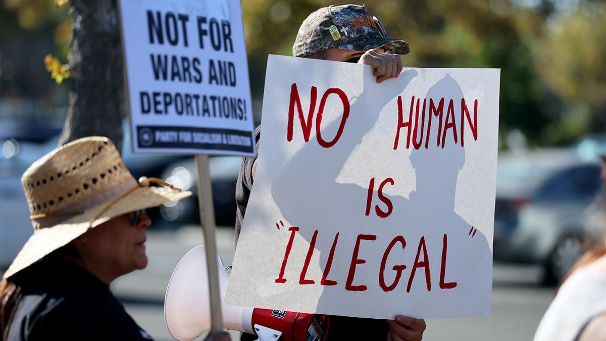 No human is illegal sign holder at protest