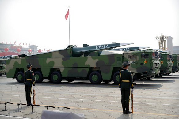 Chinese military vehicles carry weapons including a nuclear-capable missile in 2019.