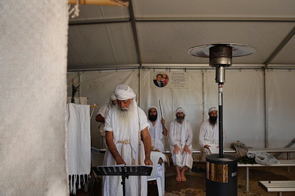 Mandaean men pray during the baptism ceremony in Wallacia.