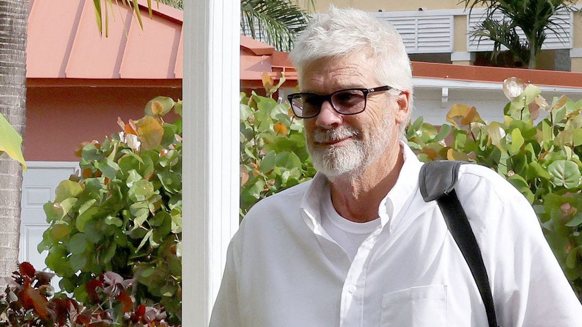 Brian Hooker walking out of a hotel in The Bahamas with his lawyer