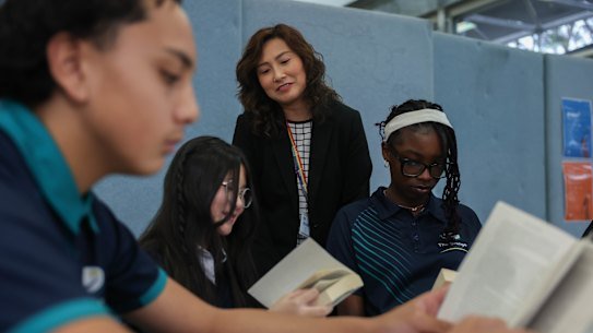 Core Literacy Coordinator Clara Tran with year 7 and year 8 students.