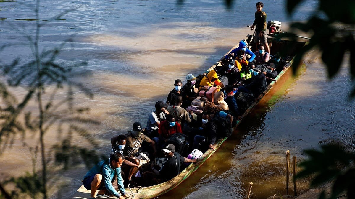 People from various countries, who were working in the KK Park compound in Myanmar, travel in a boat across the Moei river to cross over from Myanmar to Thailand, as seen from Mae Sot District, Tak Province area on October 24, 2025.