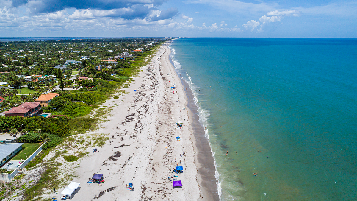Florida, Melbourne Beach, public beach with few tourists sunbathing
