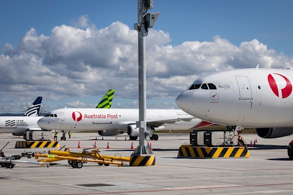 Two Qantas freighters and aircraft from Team Global Express and Texel Air are parked in front of the cargo hub on Monday.