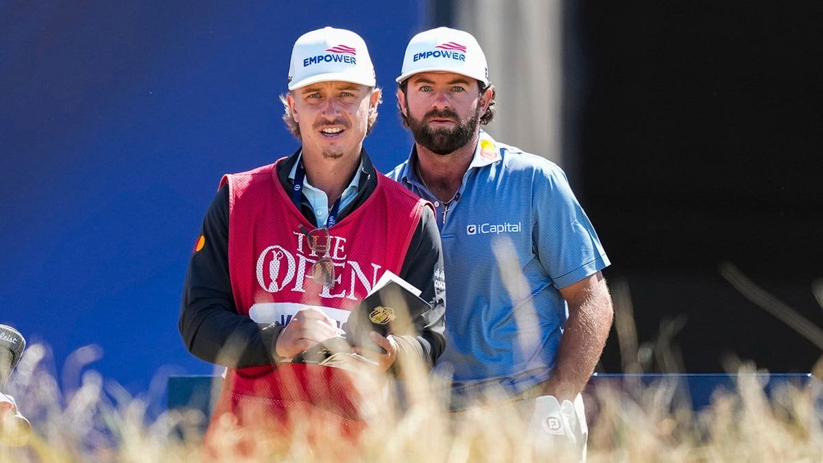 Cameron Young stands with caddie Kyle Sterbinsky on the 10th tee.