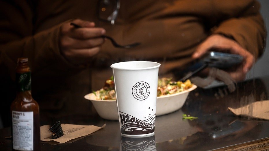 A customer dines inside a Chipotle restaurant