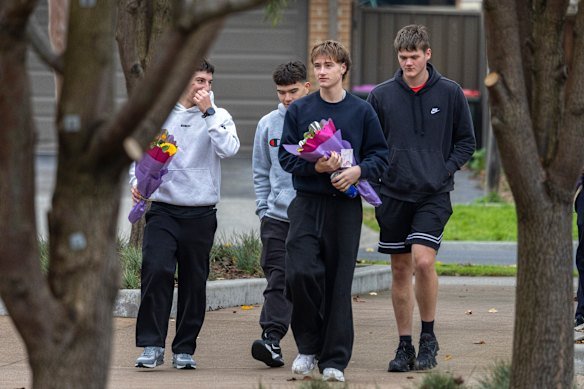 Students with flowers in memory of Fitzgerald.