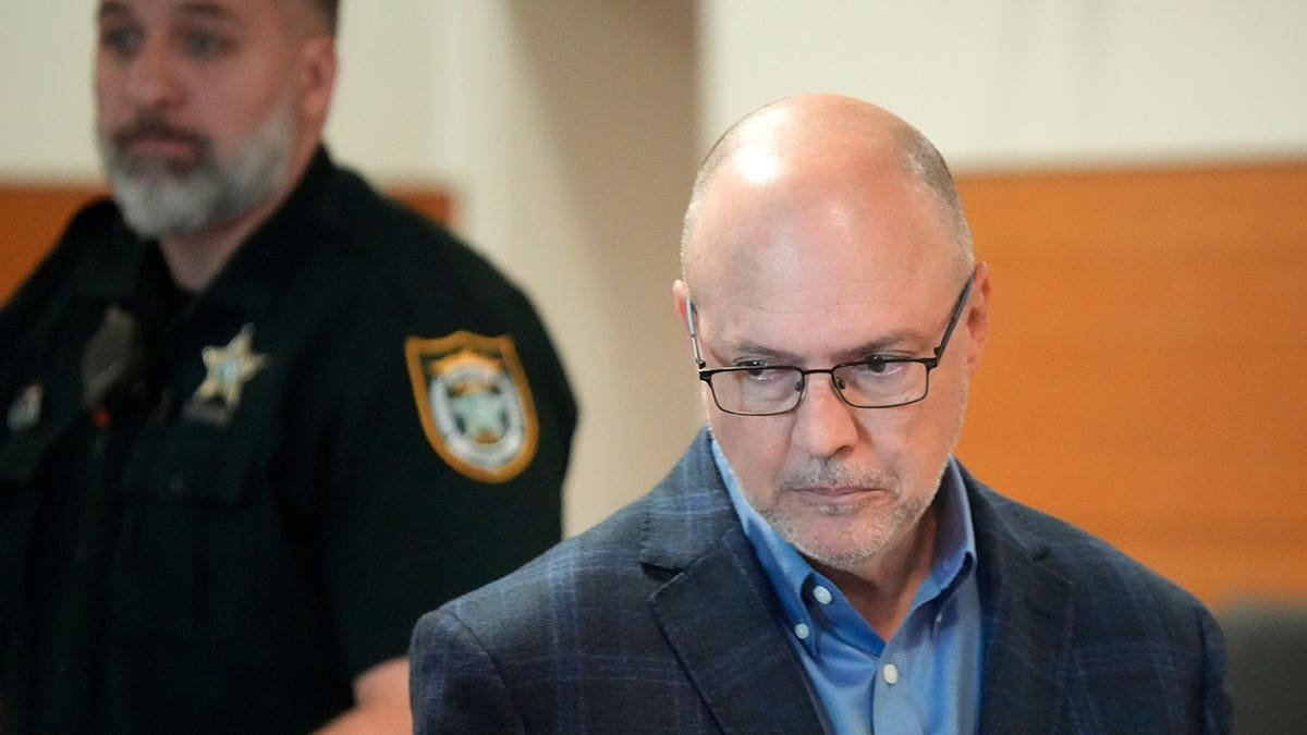 Dave Benefield, brother of Doug Benefield, returns to his seat after presenting a victim impact statement.