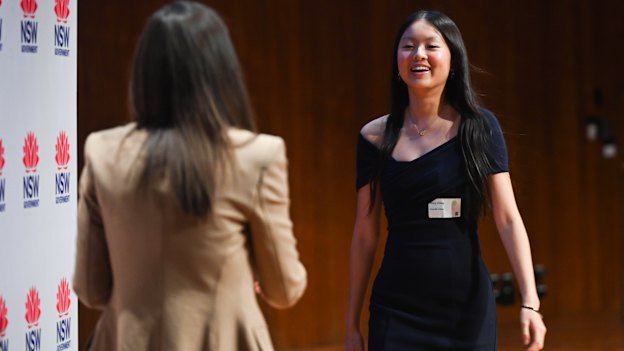 Stacy Zhang receives her awards for topping chemistry and biology from then-acting education minister Courtney Houssos.