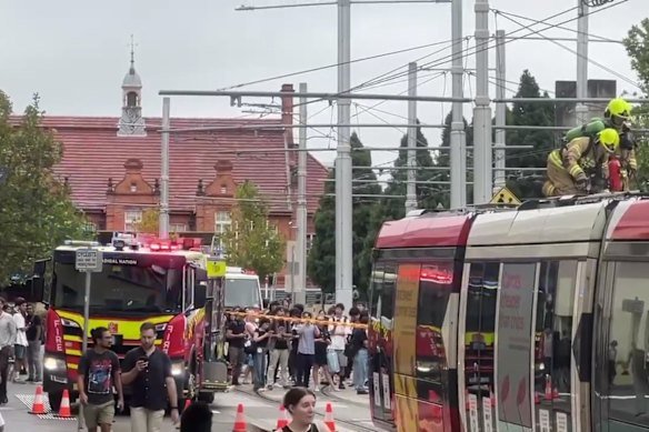 Firefighters on the roof of a smoking tram at the Chalmers Street stop near Central Station on March 5.