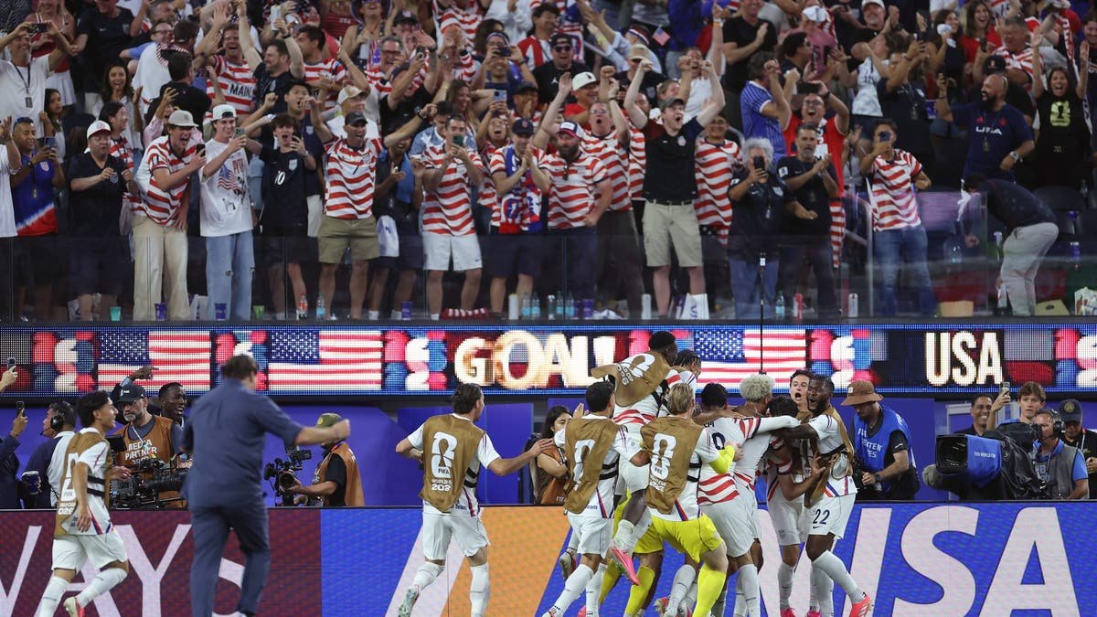 The U.S. celebrates Gio Reyna's goal against Paraguay, with Mauricio Pochettino running on the field to join in. (Sarah Stier - FIFA/FIFA via Getty Images)