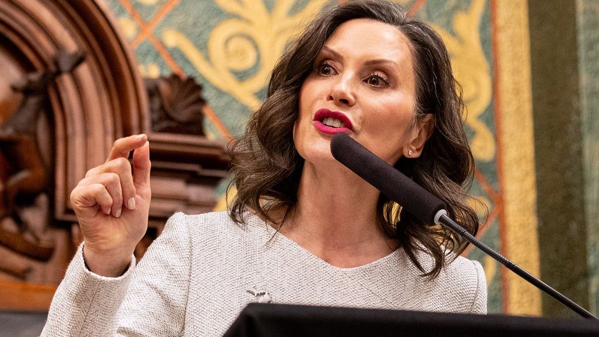 Gretchen Whitmer speaks at a podium inside the Michigan state Capitol.