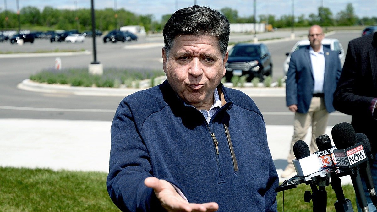 Illinois Gov. JB Pritzker talks with reporters
