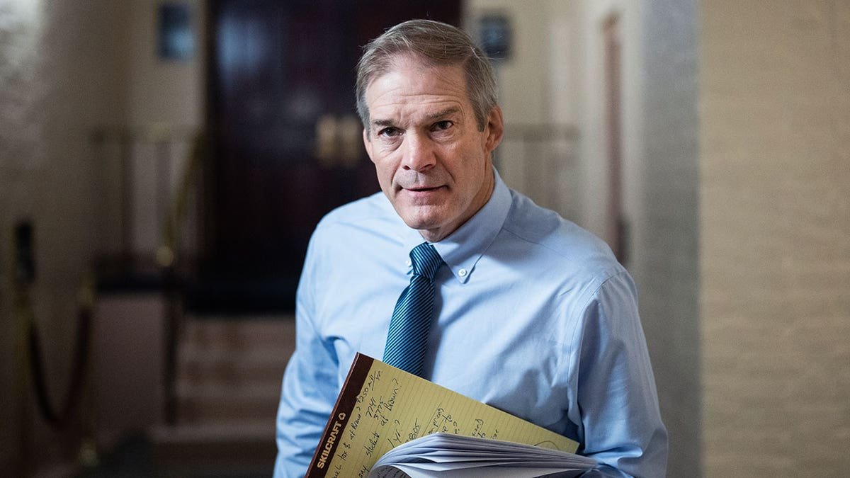 Jim Jordan speaks to media members in hallway