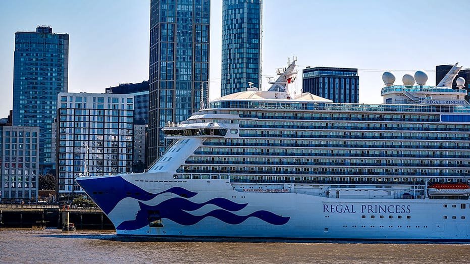 Regal Princess docked with skyscrapers in the background