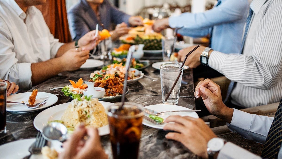Business professionals seated together at a restaurant table during dinner