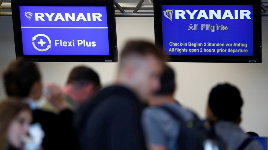 Passengers at a Ryanair terminal gate