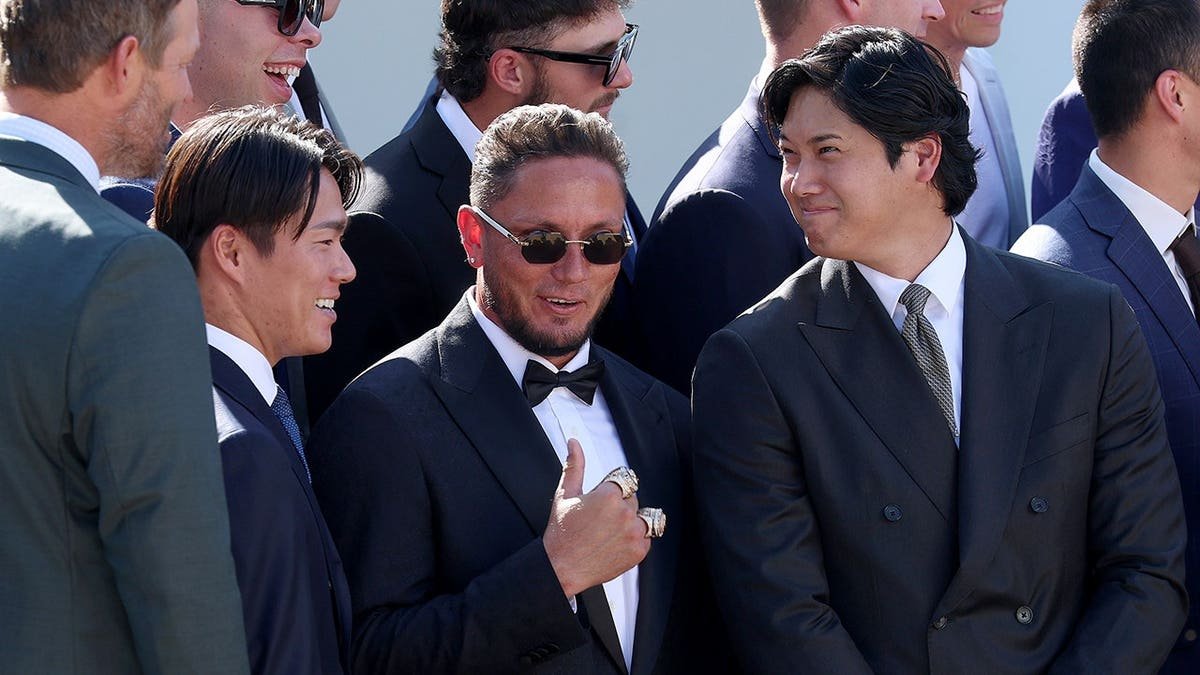 Shohei Ohtani, Miguel Rojas and Yoshinobu Yamamoto react at the White House.