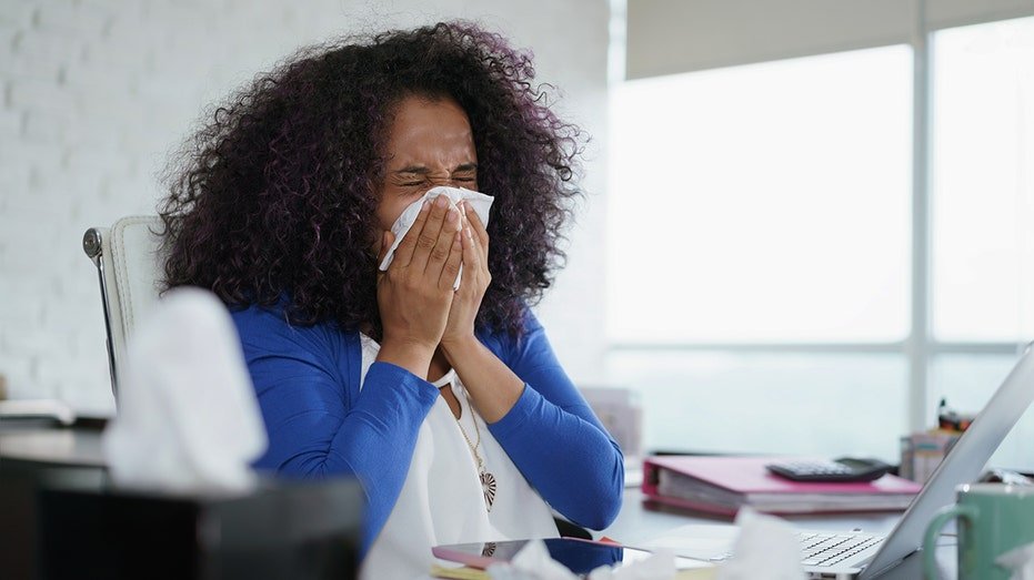 a woman sneezes