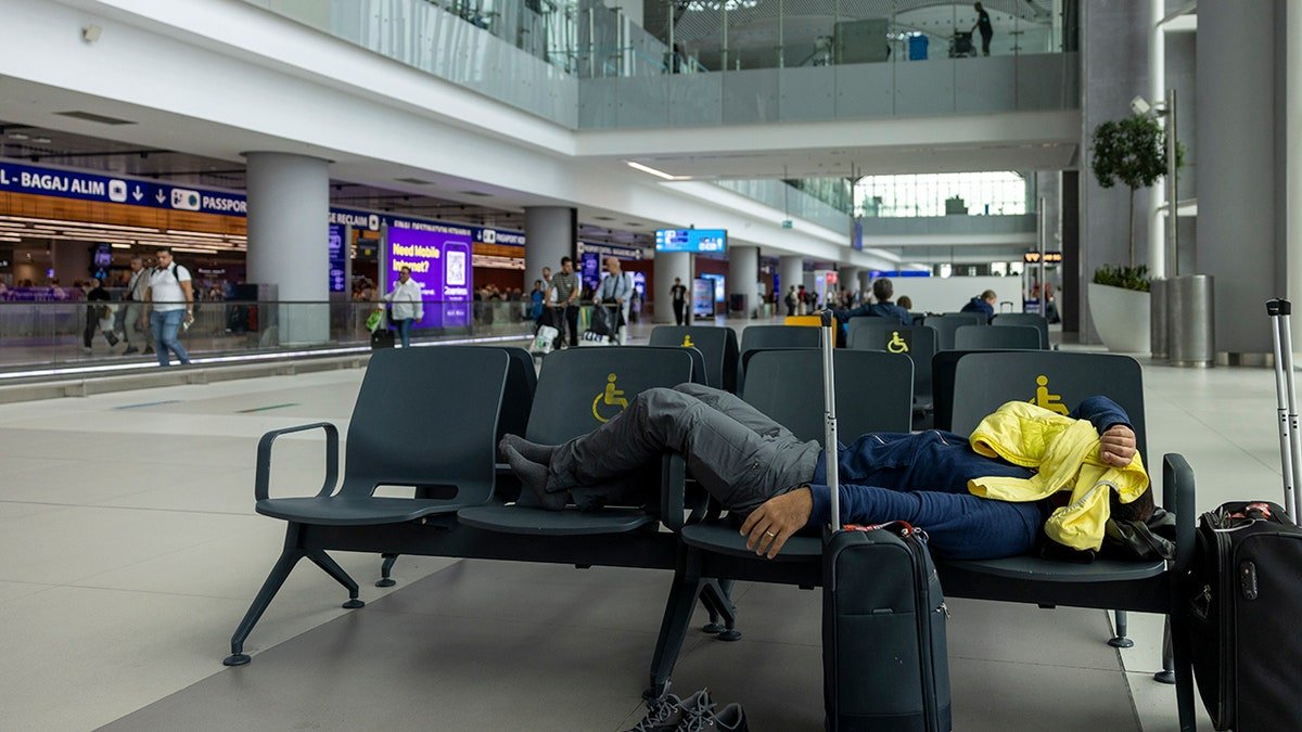 A man sleeping at the airport