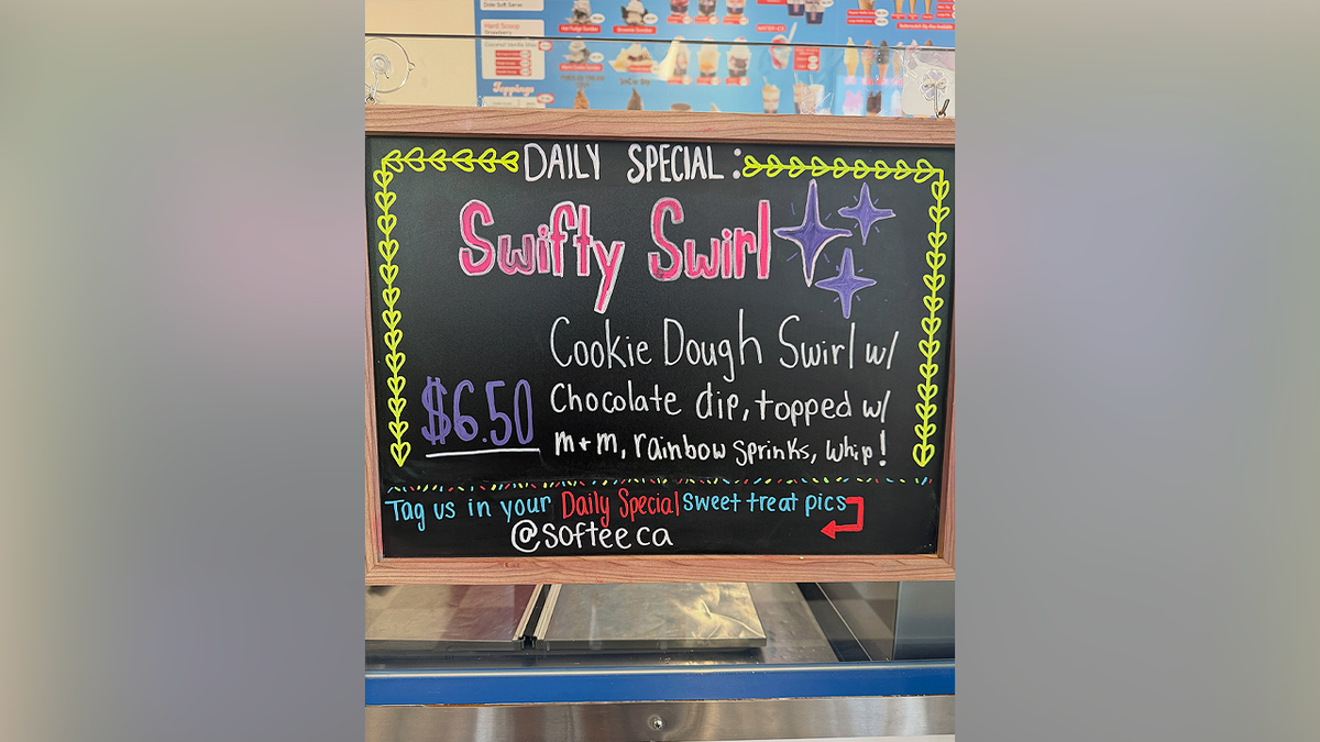 A chalkboard sign advertises Mister Softee's Taylor Swift-inspired Swiftie Swirl dessert in Camarillo, California.