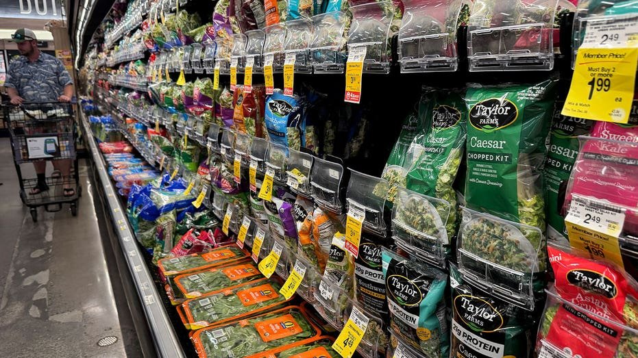 Packages of Taylor Farms salad greens displayed on shelves at a Safeway grocery store in California
