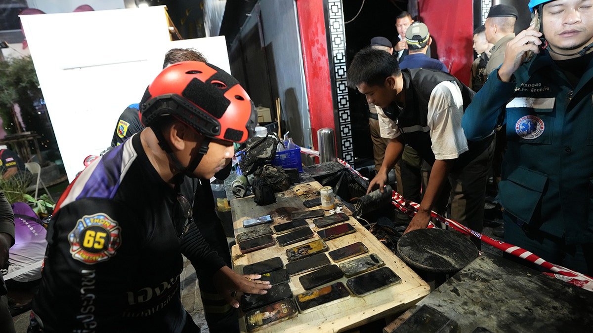 Mobile phones of victims of a fire are recovered in Bangkok