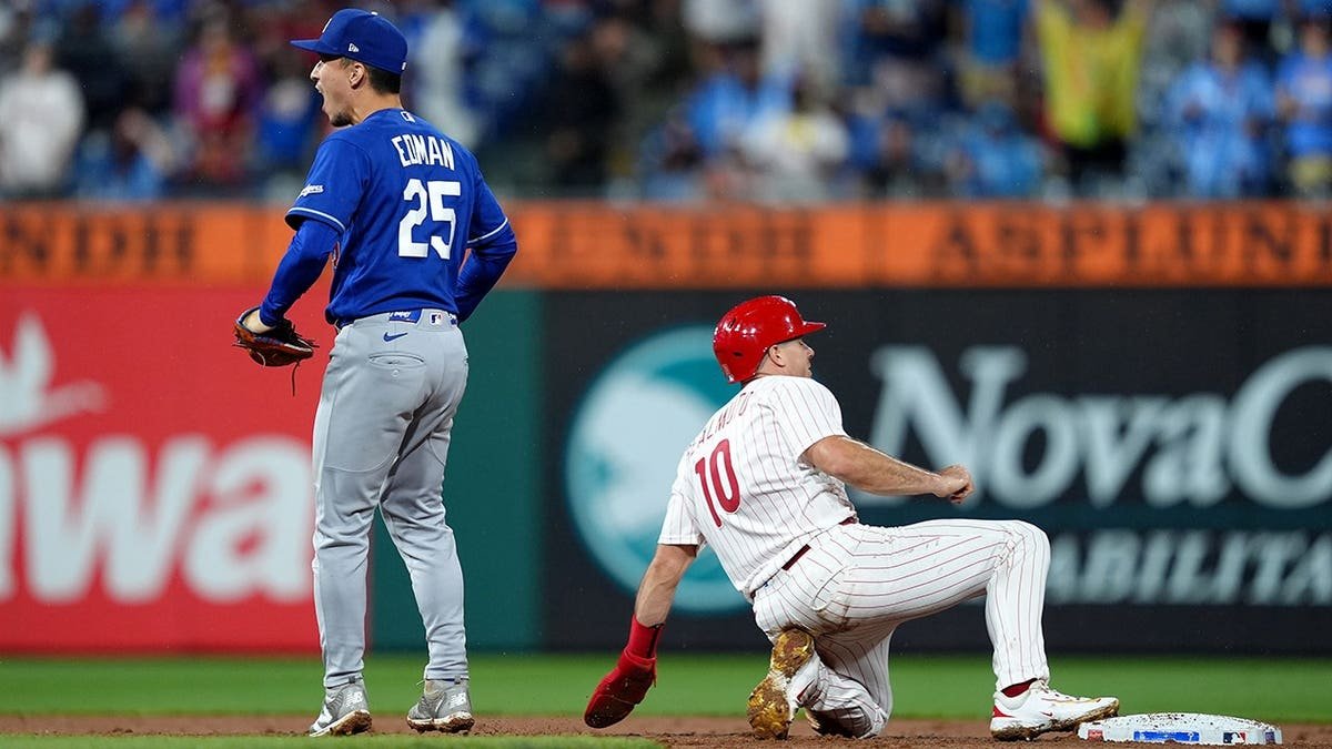 Tommy Edman reacts after tagging out JT Realmuto during a baseball game.
