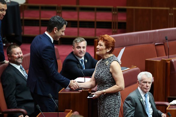 Antic shakes hands with Pauline Hanson in the Senate in March.