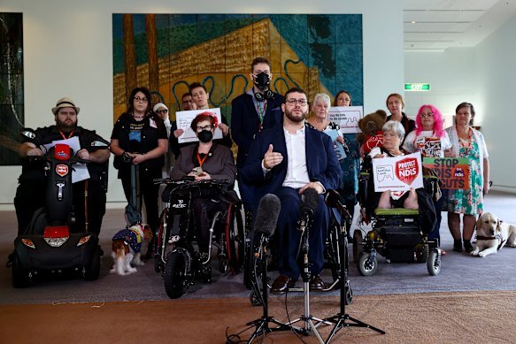 Greens Senator Jordon Steele-John and NDIS advocates during a press conference at Parliament House.