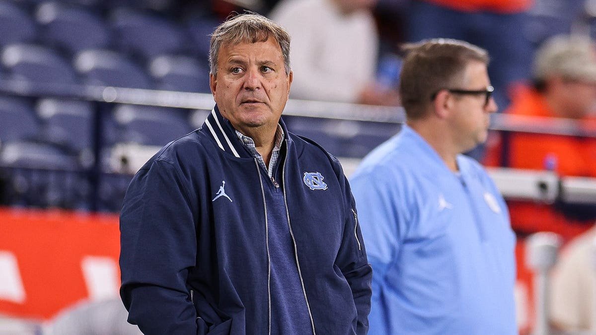 Michael Lombardi looks on before a game
