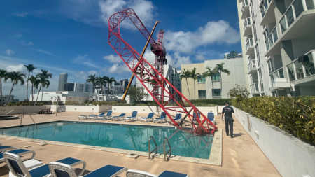Crane arm collapses into Miami condo rooftop pool area as workers cling to dangling structure Crane arm collapses into Miami condo rooftop pool area as workers cling to dangling structure
