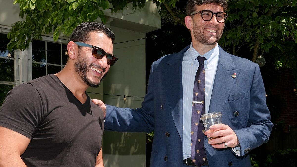 Abdul El-Sayed and Hasan Piker talk poolside at a Detroit party.