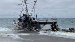 Massive fishing boat runs aground at popular beach with 1,000 gallons of diesel on board