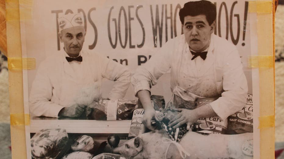 Meatcutter stands at Tops Market counter in 1963.