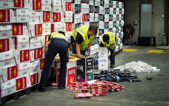 Border Force officers check illegal cigarette imports found in shipping containers in Melbourne.