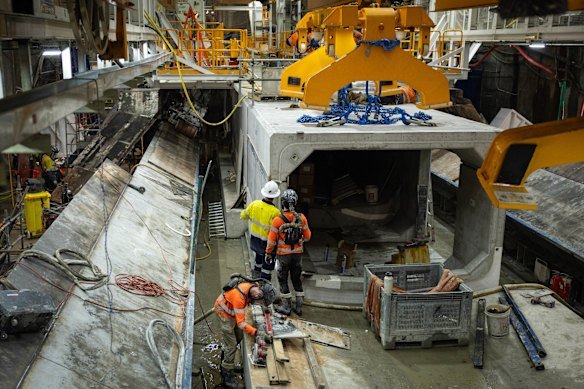 Concrete segments create a long culvert beneath what will become a roadway in one of the tunnels.
