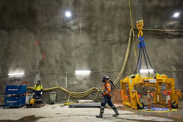 A worker with breathing apparatus walks through one of the giant launch chambers for the boring machines.