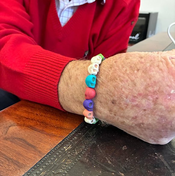 Jeff Kennett wears a bracelent of plastic skulls made by his four-year-old grandson.