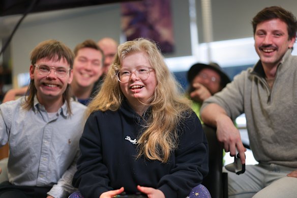 Ella, centre, is worried that losing her NDIS package means she will no longer be able to see her friends.