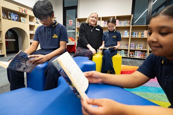 Sunshine Primary School principal Lyn Read with year 5 students Saqeef , Ivy and Afnan.