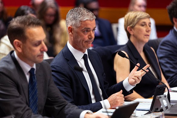 Transport Minister John Graham, centre, at a budget estimates hearing on Monday.