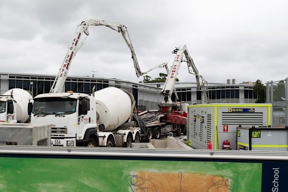 Workers fill in a huge sinkhole with cement in March 2024 to stabilise a two-storey building that had teetered on the edge.