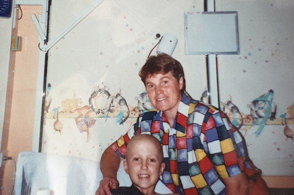 Eight-year-old Niland in hospital with his mother, Marea. He lost a kidney as a result of his childhood cancer, which he says was an “accelerant” to his ambition.
