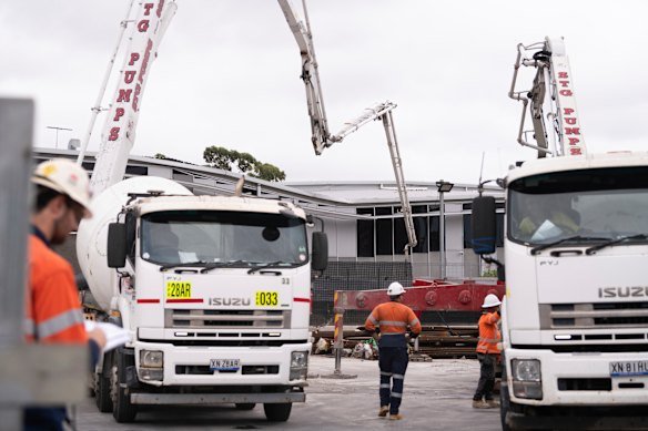 Workers fill in a large sinkhole with cement in March 2024 to stabilise a two-storey building that had teetered on the edge.